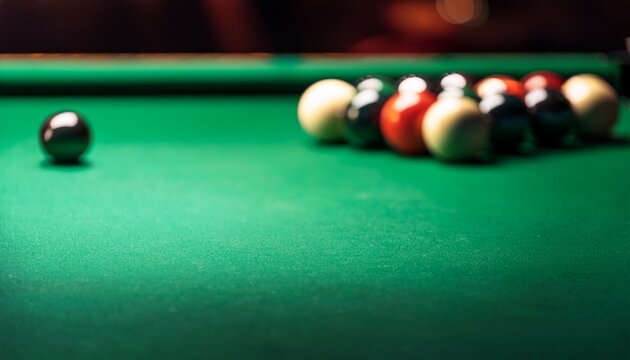 A macro view of the green velvet pool table; selective focus; blurred background; snooker table with green cloth table; a table with pool or snooker balls; billiard table with balls and cue; games