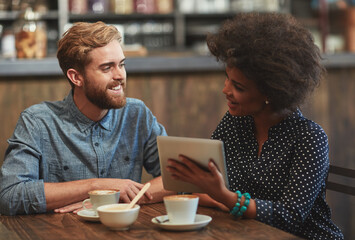 Couple, tablet and smile on date in cafe with social media streaming, bonding and online information. Interracial, people and happy in coffee shop with tech app for post update, discussion and relax