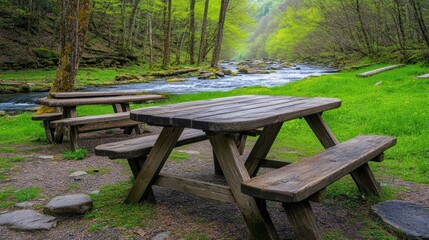 Fototapeta premium Wooden picnic tables by a babbling brook