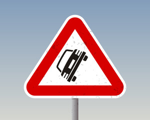 Slippery Road Warning Sign – Black Car Skid Icon on Triangular Red Sign - High Quality Stock Image