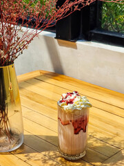 Blueberry frappe. Blueberry milkshake with whipped cream in glass cup on cafe table. Cool summer...