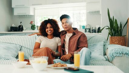 Couple, lounge or watching tv to relax on sofa for romance, love or bonding together in home....