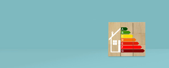 banner of house energy efficiency rating level in wooden cube on blue background