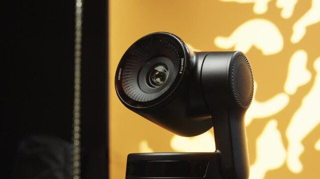 Closeup reveals details of an industrial PTZ camera with yellow backlight