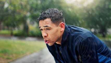 Athlete, man and tired with breathing at park for running fatigue, performance recovery and cardio...