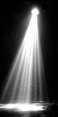 Dramatic monochrome shot of a spotlight illuminating a dark stage surface