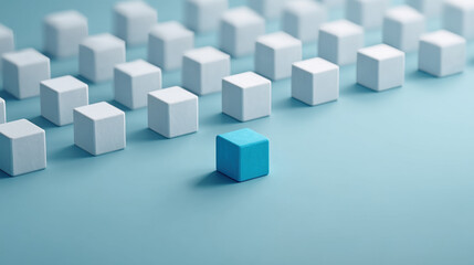 A striking image featuring a single blue cube standing out among numerous white cubes on a soft blue background, symbolizing individuality and uniqueness.