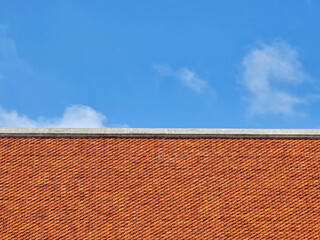 brick building with a red roof against the white sky