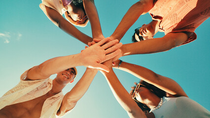 Below, hands together and friends with blue sky, vacation and travel with summer holiday. Low...
