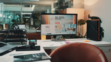 Empty office, computer and monitor on desk for business strategy, call center and digital display. Interior, workplace and screen on table with pc for company growth info, website or customer service