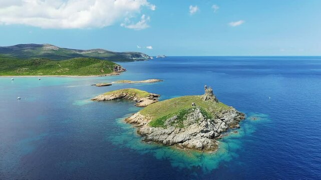 Tamarone Beach runs along a green coastline, in Europe, in France, in Corsica, towards Bastia, on the edge of the Mediterranean Sea, in summer, on a sunny day.&nbsp;