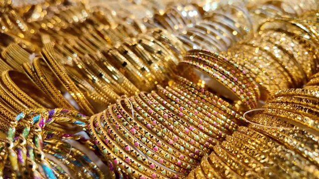 Beautiful collection of gold bangles at market stall in afternoon