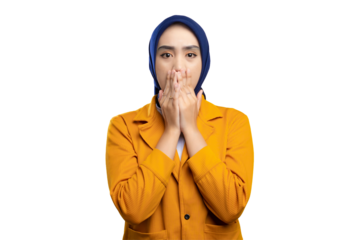 Shocked young Asian woman covering her mouth with both hands, looking at the camera, expressing shock isolated on transparent background