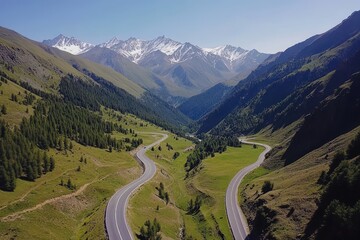 Fototapeta premium A winding road through a picturesque mountain valley landscape