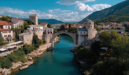 Picturesque view of the historic stone bridge amidst scenic landscapes and vibrant town architecture under a bright blue sky.