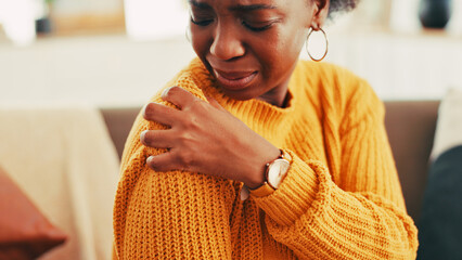 Hands, woman and shoulder pain on couch at house for discomfort, joint inflammation and...