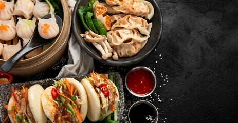 Tasty and hot chinese dumplings with sauces. Asian food concept.
