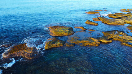 Aerial View of Rocky Shoreline and Clear Turquoise Water