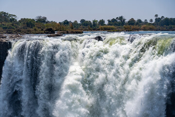 White water masses at the top of the victoria falls in zimbabwe crashing down the cliff face 