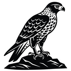 Fototapeta premium hawk perched on a rock silhouette
