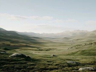 Naklejka premium Serene mountain valley landscape with rolling hills, grass, and rocks under a clear sky.