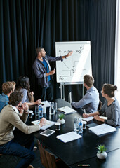Man, presentation and colleagues in office or meeting, business planning and white board demonstration. Presenter, company and goals or idea with strategy, collaboration with professional for project