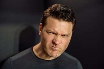 Fototapeta premium Studio shot of grumpy man looking at camera.