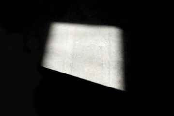 sunlight falls through window onto black wall