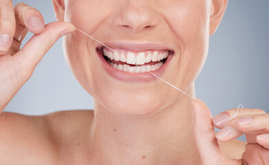Face, woman and floss in studio background for dental care, gum health and fresh breath. female...