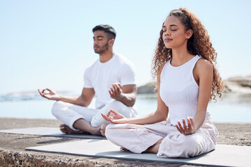 Beach, couple and lotus pose for meditate, mindfulness and holistic wellness outdoor. People, man and woman with zen for bonding in California to relax, peace and mental health in relationship
