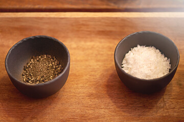 Cooking, food and salt and pepper in kitchen for dinner, supper and lunch meal prep in home. Spices, diet and table with seasoning, flavour and ingredients for culinary cuisine, nutrition or wellness
