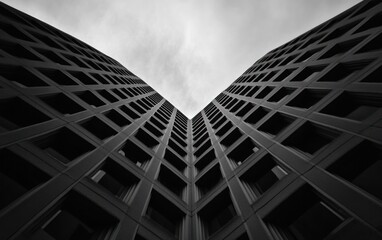 Fototapeta premium Symmetrical Gray Buildings Under Cloudy Sky