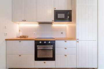 Elegant contemporary kitchen inside house or apartment. Interior cosy kitchen with white cabinets...