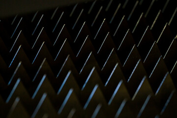 macro sharp metal teeth, total black background, closeup steel metal triangles, metalworking...