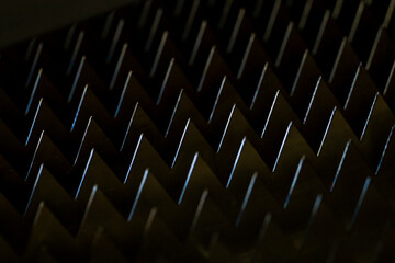 macro sharp metal teeth, total black background, closeup steel metal triangles, metalworking...