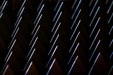macro sharp metal teeth, total black background, closeup steel metal triangles, metalworking...