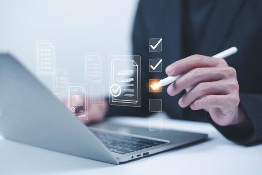 Business performance checklist concept, Businessman using laptop take an assessment,An businessman checklist online survey filling form list options business employee security procedures.
