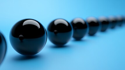 Abstract Spherical Shapes on Blue Background: Glossy Black Balls Creating Minimalist Modern Decor in Studio Photography