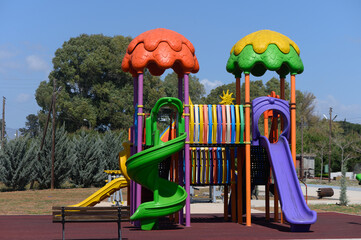 Brightly colored playground structure invites play and imagination in a sunny park setting during...