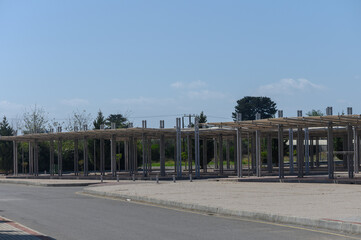 Constructed framework of a vibrant outdoor market awaits its lively transformation under a blue sky...