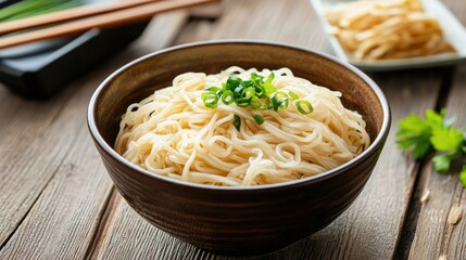 Freshly Cooked Noodles Served in a Rustic Bowl with Chopped Green Onions on a Wooden Table