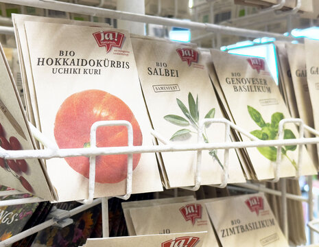 Organic seed packets with hokkaido pumpkin, sage, and genovese basil at display