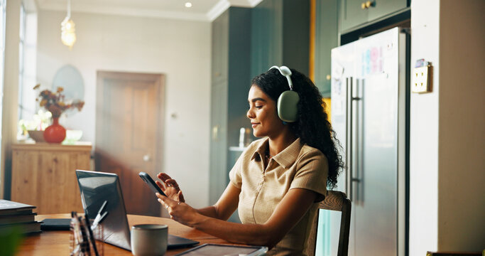 Girl, student and phone with headphones in kitchen for online course, e learning or texting on mobile app. Woman, smartphone and social media on break for education, scholarship or research at house - Powered by Adobe