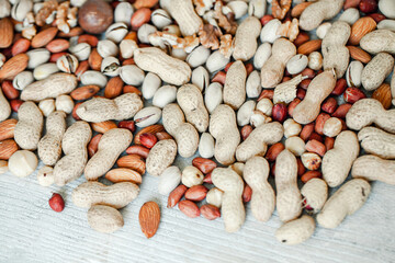 Assorted nuts for a background Almond, walnut,cashew, pistachios, hazelnuts, peanuts, Macadamia Collection of different varieties of nuts. Composition with dried fruits Healthy food. Organic