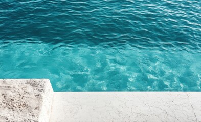 Obraz premium Minimalist white pool edge overlooking turquoise water, simple shapes, white background, textured, top view.