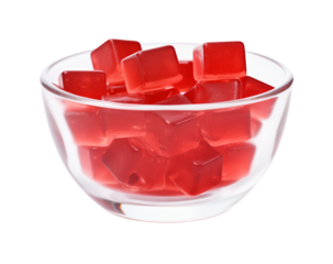 Close up of a clear bowl filled with red cube shaped candies on a white background studio shot  on transparent background png