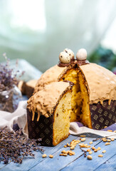Panettone is the traditional Italian dessert for easter in 2021. Homemade panettone covered in chocolate and sprinkles. Bread served as dessert.