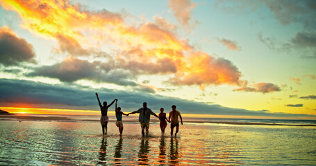 Sunset, holding hands and friends in ocean water for vacation, holiday and summer trip on tropical...