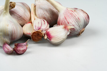 Fresh Garlic Bulb with Peeling Skins. purple garlic.  Suitable for cooking, health, food introduction, nutrition topics.