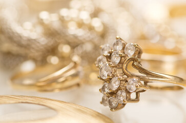 A collection of luxury gold rings, diamond earrings, gemstone necklaces, and elegant jewelry pieces captured on soft, elegant backgrounds. Perfect for use in advertising, fashion editorials, jewelry c